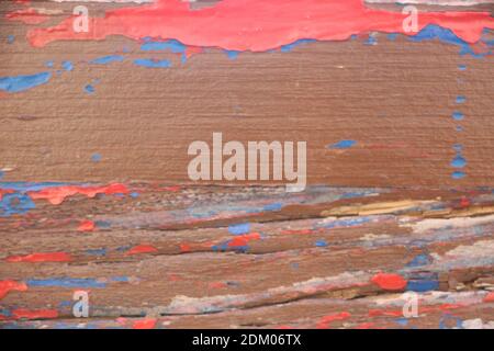 Background gloomy charred wooden fence in brown and red colors. Stock Photo
