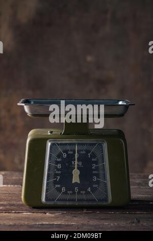 Green Vintage Scales on Wooden Table Stock Photo