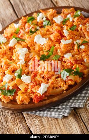 Greek tomato scrambled eggs Strapatsada closeup in the plate on the table. vertical Stock Photo