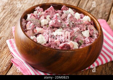Salad of boiled beets, onions, garlic and feta dressed with yogurt close-up in a bowl on the table. horizontal Stock Photo