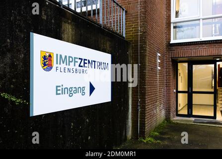 Flensburg, Germany. 15th Dec, 2020. A sign reading "Impfzentrum Flensburg" stands in front a building belonging to the Bundesanstalt für Immobilienaufgaben (BImA). Mayor Lange came to inspect and hand over the
