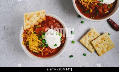 Homemade Turkey bean chili topped with sourcream cheese and green onions, selective focus Stock Photo