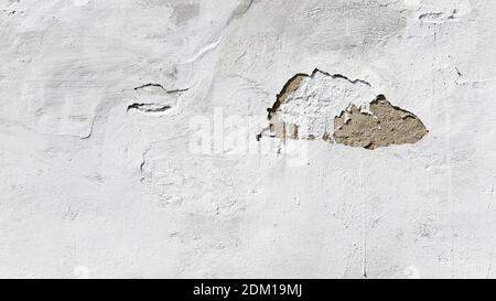 Texture of old and grungy plastered white wall with chipped. Grunge abstract background. Stock Photo