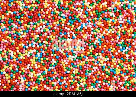 Background of colorful round-shaped candies filled with chocolate, multi-colored balls. Stock Photo