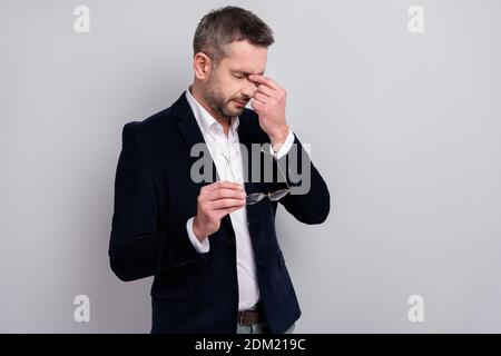 Portrait of his he nice attractive sad tired mature man entrepreneur wearing classy look holding in hands specs touching nose suffering feeling bad Stock Photo