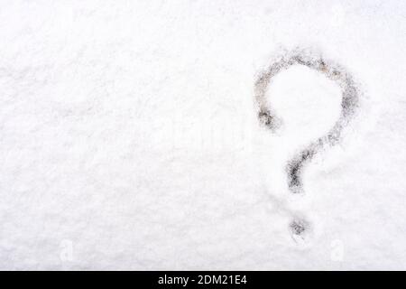 question mark written on fresh white snow in winter time Stock Photo