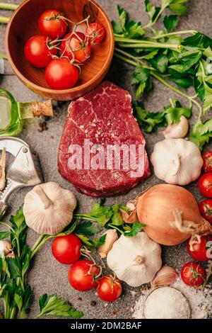 Grass fed beef steak from the tenderloin.Fresh meat preparation. Raw meat seasoning.Portioned filet mignon with spices and ingredients.Dry aged premiu