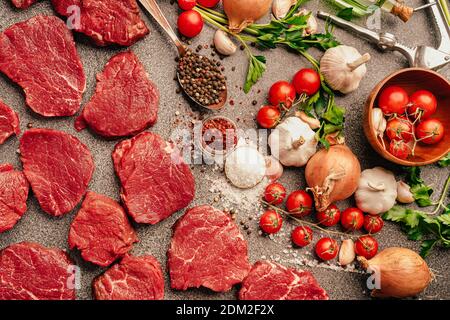 Grass fed raw beef steak from the tenderloin.Portioned filet mignon with spices and vegetable ingredients.Dry aged premium quality fresh red meat prep Stock Photo