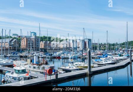 The River Ely marina at Cardiff in south wales with boardwalks and a large number of boats and general leisure craft moored up. A sunny and blue sky. Stock Photo