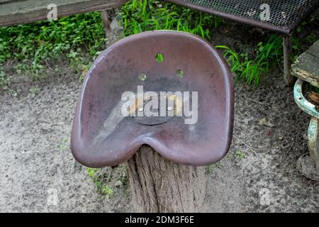 Old Rustic Tractor seat made in to a chair . High quality photo Stock Photo