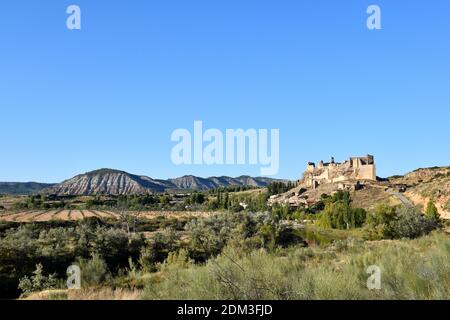 Village of Zorita de los Canes with its castle and mountains behind. Stock Photo