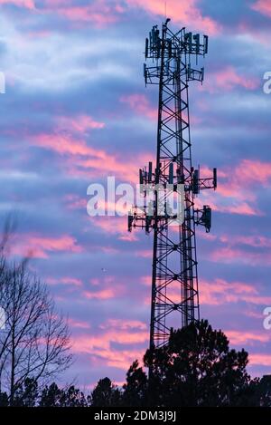 Cell phone tower silhouetted against a colorful sunset sky near Atlanta, Georgia. (USA) Stock Photo