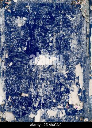 BACKGROUND TEXTURE - Old posters removed from a blue notice board leaving torn remains Stock Photo