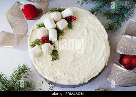 christmas cake with decor and fir branches on gray table Stock Photo