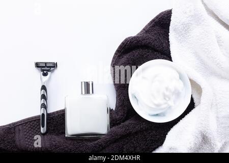 Flat lay composition with men's shaving accessories with  copy space on white and dark towel background. Stock Photo