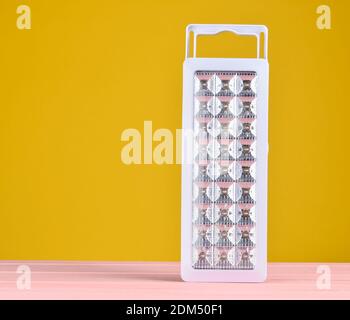 Plastic led flashlights on yellow background Stock Photo