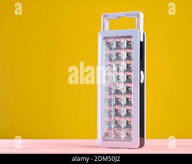 Plastic led flashlights on yellow background Stock Photo