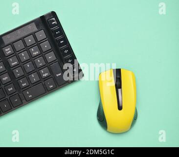 Wireless mouse and keyboard isolated on blue pastel background. Top view, minimalist trend Stock Photo