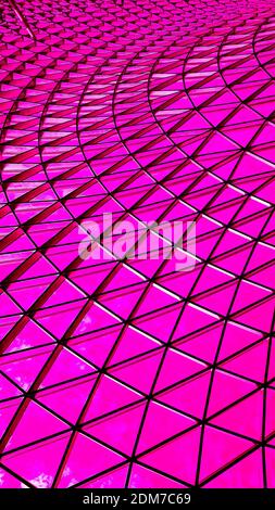 Full frame background from a geometric shaped steel glass rooftop dome. The ceiling is located in Changi airport, Singapore, here in pink purple red Stock Photo