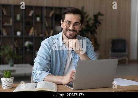 Portrait of happy young man work on laptop Stock Photo