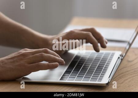 Close up of man typing on modern laptop keyboard Stock Photo