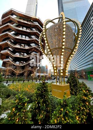 The Vessel, also known as the Hudson Yards Staircase (designed by architect Thomas Heatherwick) with lamp and Holiday decorations. Stock Photo