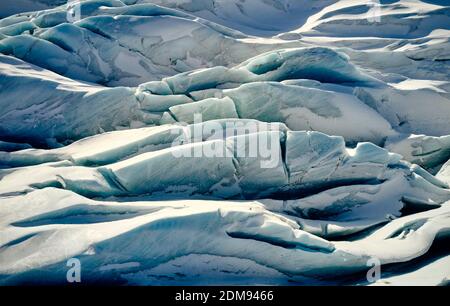 Layers of cracked ice covered with white snow in mountains in winter in Iceland Stock Photo