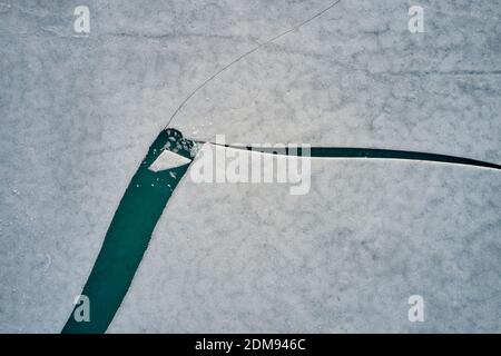 Top view of ice floes covered with snow on water of cold sea in winter in Iceland Stock Photo