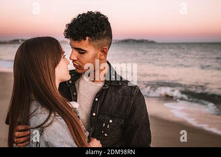 Nice Picture Of A Young Couple On The Beach Looking At Each Other Stock Photo