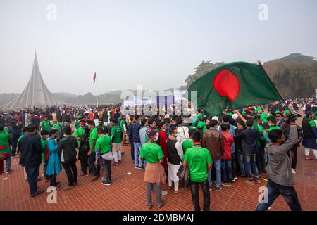 People gather at the national monument to mark the country's Victory Day.Bangladesh is celebrating the 49th anniversary of its victory in the Liberation War as tributes poured in for the martyrs of the struggle for independence at the National Monument in Savar. Stock Photo