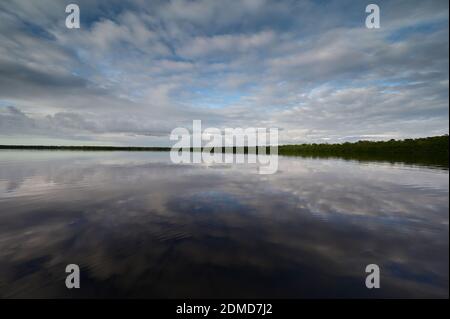 Winter cloudscape reflected in tranquil water of Coot Bay in Everglades National Park in late afternoon. Stock Photo