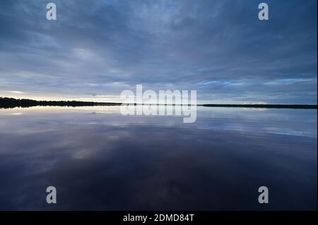 Winter cloudscape reflected in tranquil water of Coot Bay in Everglades National Park in late afternoon. Stock Photo