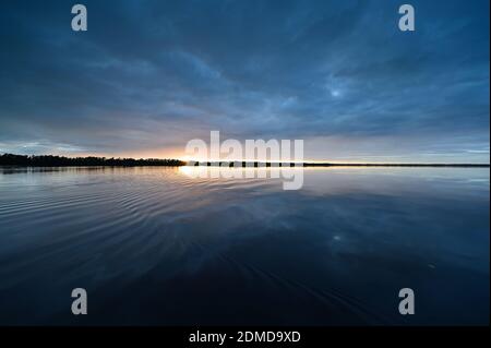 Winter cloudscape reflected in tranquil water of Coot Bay in Everglades National Park in late afternoon. Stock Photo