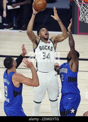 NO FILM, NO VIDEO, NO TV, NO DOCUMENTARY - File photo dated August 20, 2020 of Bucks forward Giannis Antetokounmpo (34) scores between Magic center Nikola Vucevic (9) and forward Gary Clark (12) during the NBA Playoffs game of the Orlando Magic versus Milwaukee Bucks during the NBA Restart at Disney’s ESPN Wide World of Sports in Orlando, FL, USA. Milwaukee Bucks star Giannis Antetokounmpo has signed a contract extension worth a reported $228.2m - the richest in NBA history. The two-time Most Valuable Player, 26, has agreed a five-year deal. Photo by Stephen M. Dowell/Orlando Sentinel/TNS/ABAC Stock Photo