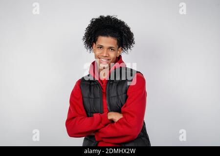 A casual smiling African American young man posing isolated on a white background in a studio. People lifestyle concept. Stock Photo