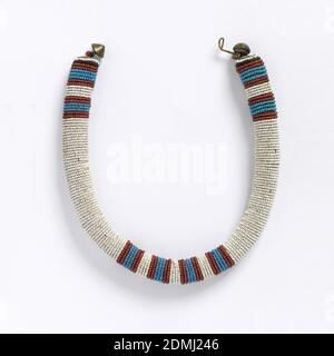 Necklace, Medium: glass beads, metal fasteners, Tubular necklace with horizontal rows of white glass beads, with four red and blue stripes at the center front and back. Cone-shaped metal fasteners., South Africa, late 19th–early 20th century, jewelry, Necklace Stock Photo