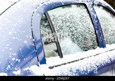 Car windows and wipers covered with snow in winter Stock Photo