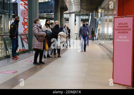 LUBIN, POLAND - DECEMBER 05, 2020. People with face masks due to pandemic Covid-19 stay in the queue in shopping mall Cuprum Arena. Stock Photo