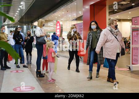 LUBIN, POLAND - DECEMBER 05, 2020. People with face masks due to pandemic Covid-19 stay in the queue in shopping mall Cuprum Arena. Stock Photo