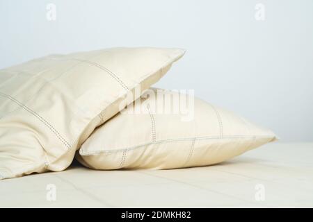 couple comfortable soft yellow pillows on bed Stock Photo