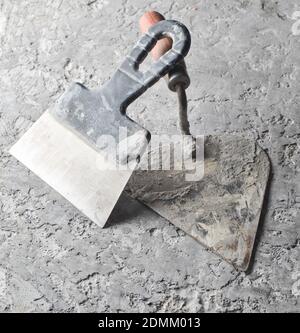 Building tools on a gray concrete background. Spatula, trowel Stock Photo