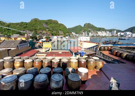 Cat Ba Island, Quang Ninh Province, Vietnam - November 13, 2020: Big production facilities fish sauce in Vietnam. Fishermen, Cat Ba Bay, profession of Stock Photo