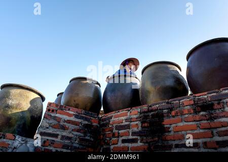 Cat Ba Island, Quang Ninh Province, Vietnam - November 13, 2020: Big production facilities fish sauce in Vietnam. Fishermen, Cat Ba Bay, profession of Stock Photo