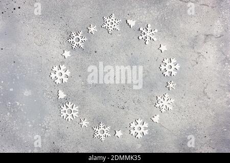 Christmas composition. Christmas frame made of snowflakes on gray stone background. Winter concept. Flat lay, top view, copy space. Stock Photo
