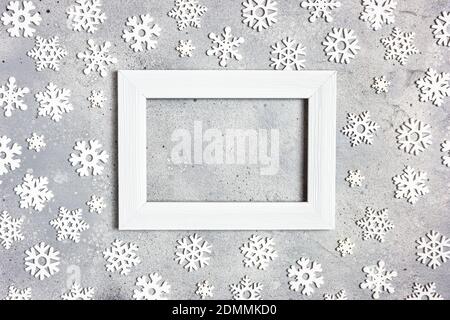Christmas, winter composition. Xmas decorations, photo frame and snowflakes on gray stone background. Christmas, New Year, winter concept. Flat lay, t Stock Photo
