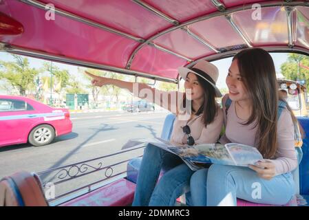 Beautiful asian tourists woman enjoy travel together in urban city downtown on vacation Stock Photo