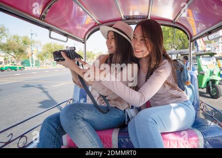 Beautiful asian tourists woman enjoy travel together in urban city downtown on vacation Stock Photo
