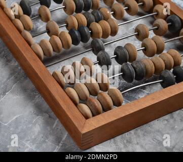 Ancient wooden abacus on a gray concrete background close up Stock Photo