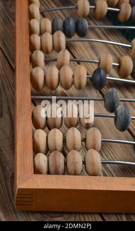 Ancient wooden abacus on a rustic wooden background close uop Stock Photo