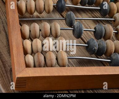 Ancient wooden abacus on a rustic wooden background close uop Stock Photo